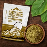 Yellow BC Kratom bag laying on a wooden table beside a bowl of Yellow Vietnam Kratom Powder